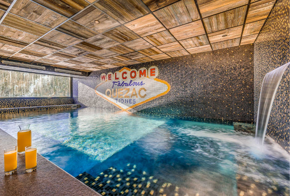 The indoor pool of Chalet Quezac in Tignes, with Las Vegas style tiles and a fountain. Perfect for a celebration ski holiday in a luxury chalet.