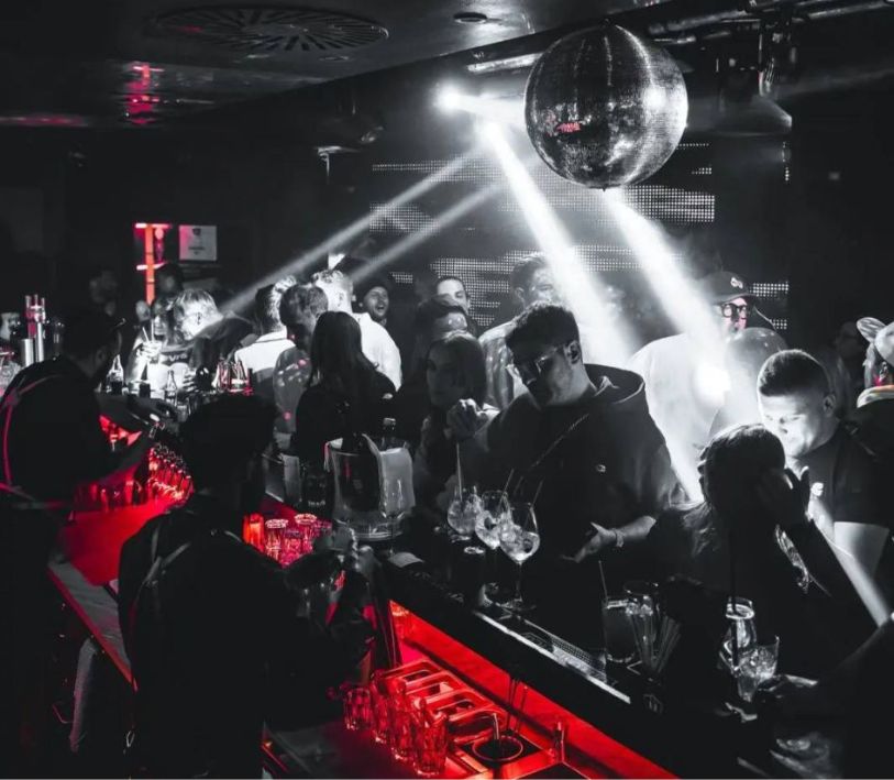 Black and white image with red mood lighting of K Club in Lech. 