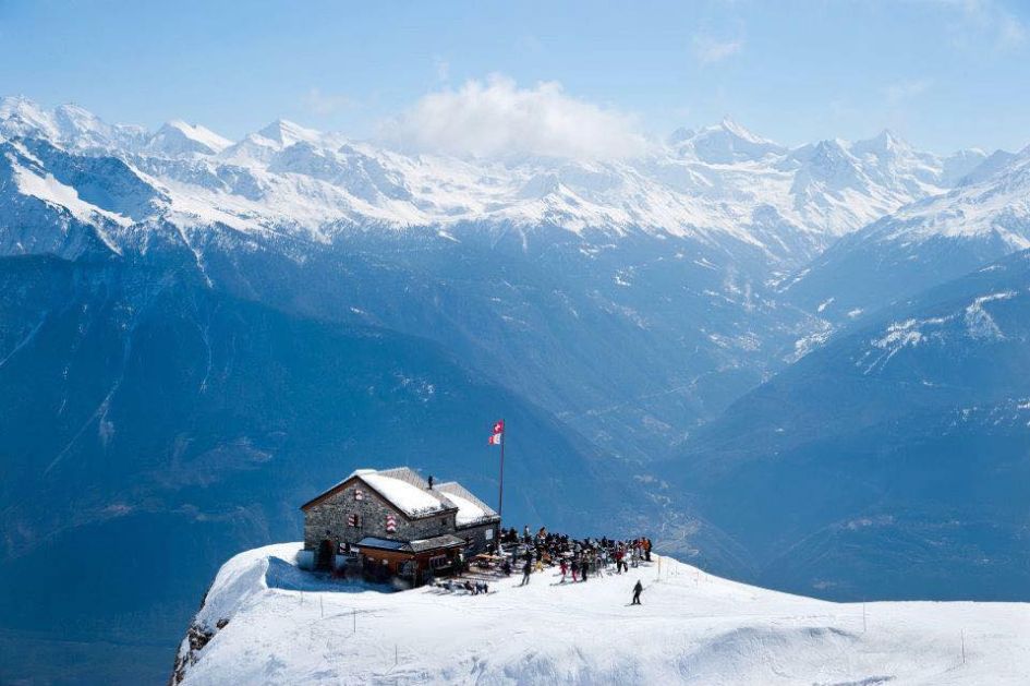 Breathtaking mountain views with Cabanes des Violettes, a mountain restaurant in Crans Montana, isolated on the slopes. 