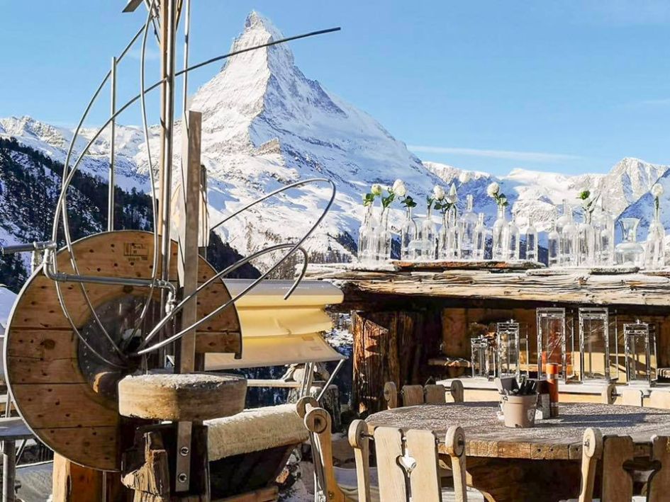 Tables on the terrace and the Matterhorn in the background at one of Zermatt's best mountain restaurants, Chez Vrony.